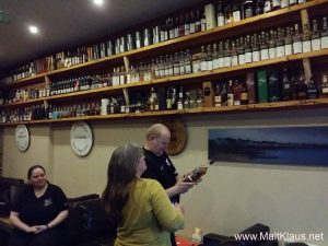 Erik and Jo browsing the whisky selection under the watchful eye of Fiona (left)